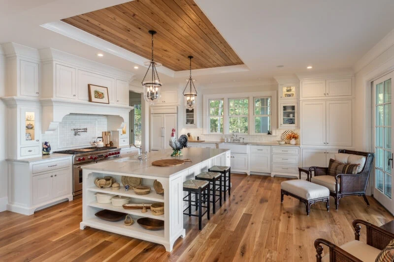 Kitchen Island with Chairs Around it With View Appliances in Kitchen