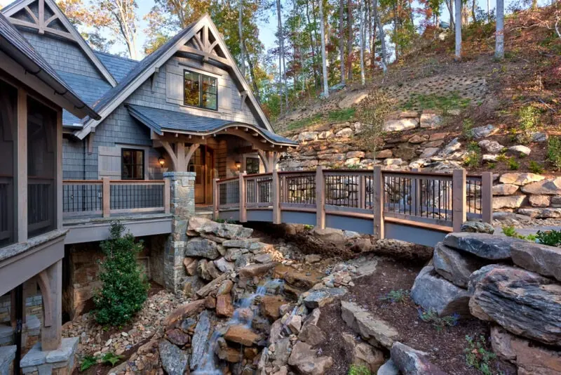Lake Keowee House with a bridge and waterfall in its landscaping