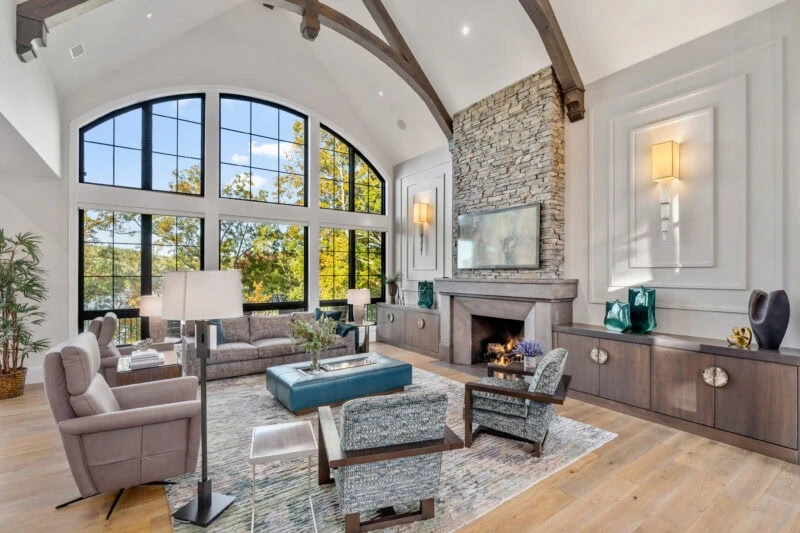 A living room with a couch and two recliners and two arm chairs.