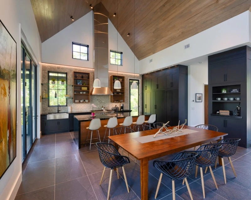 Kitchen with island bar and black cabinets