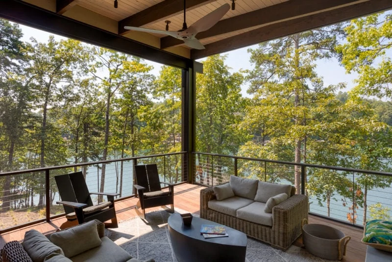 Outdoor sitting area with view of wilderness and lake