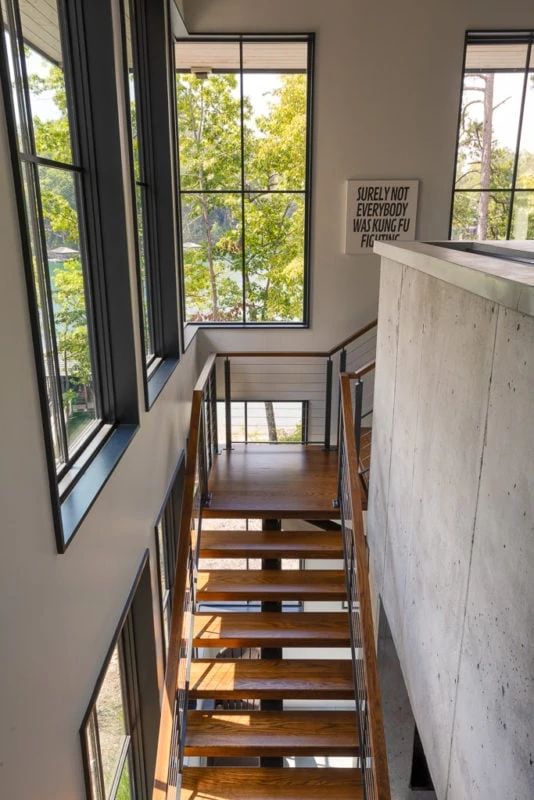 Stairway with view of lake out of big windows