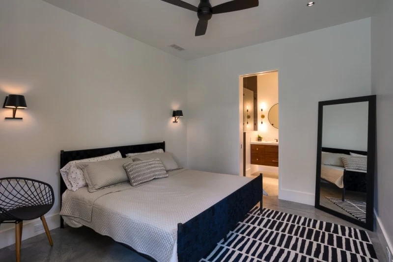 Bedroom with fancy rug and full length mirror