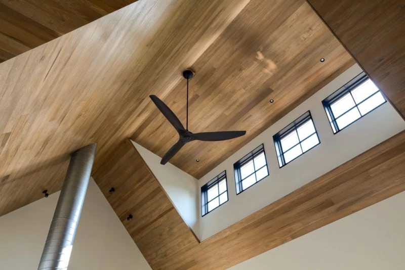 Modern ceiling fan hun on wood ceiling