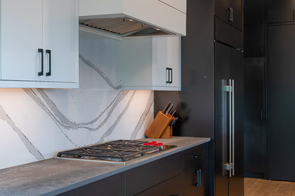 image of kitchen with black appliances and white cabinets