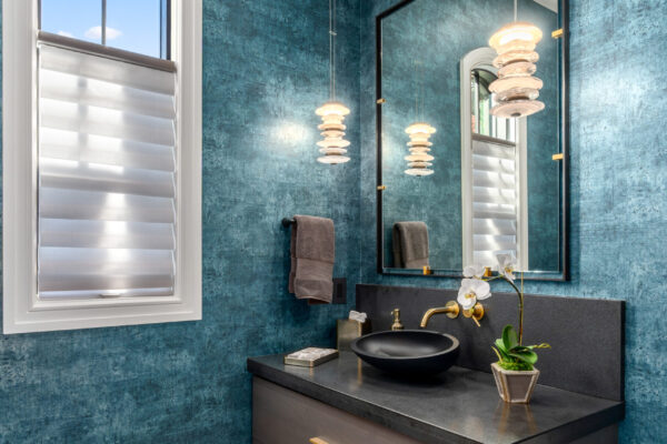 bathroom vanity with blue wallpaper