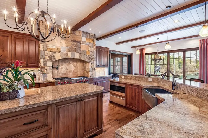 Kitchen Island and Sink Around it With View of Dining Table and Appliances in Kitchen