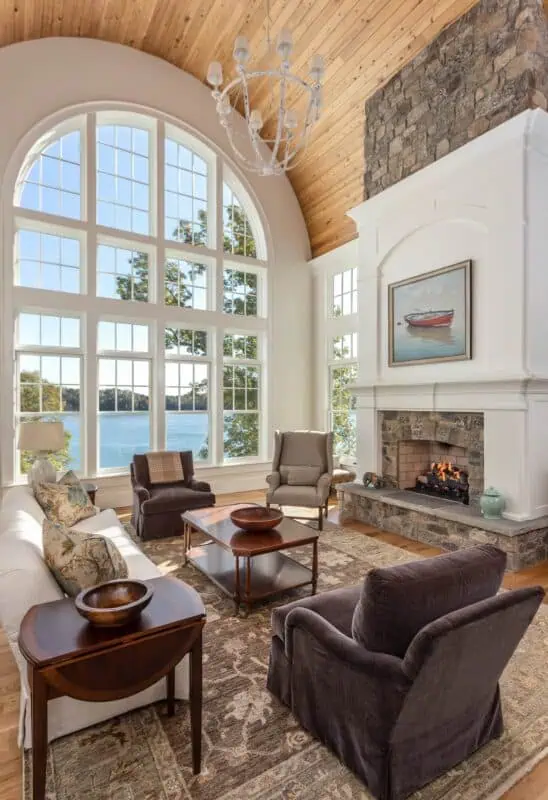 Large curved window with a lake view in a living room