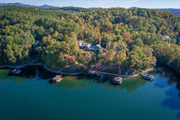 Aerial image of home surrounded by trees and lake