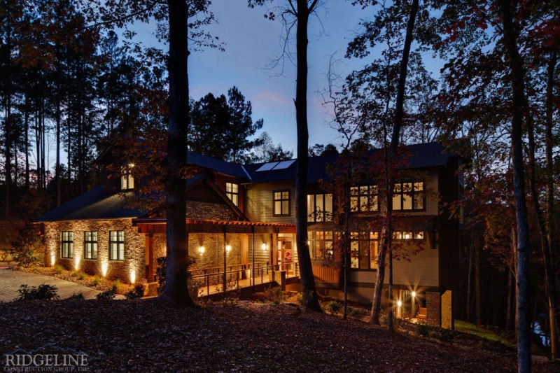 view of full house outide at dusk with lights on