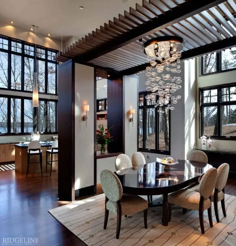 view of elegant dining room with with kitchen and windows in the background