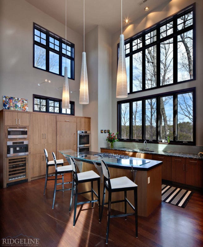 view of kitchen with windows to the ceiling and hanging light fixtures