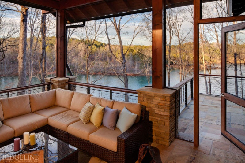 outdoor seating area overlooking wooded lake