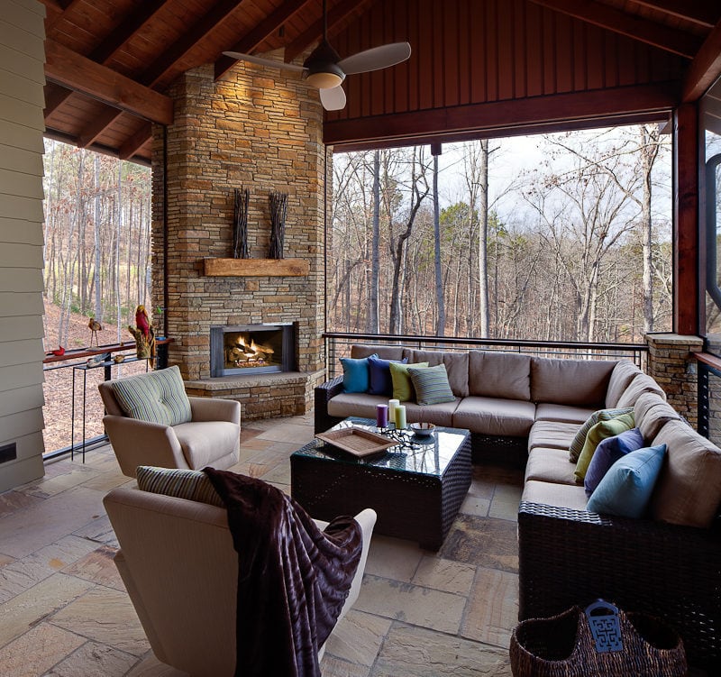 Covered outdoor living area with sectional couch and chairs