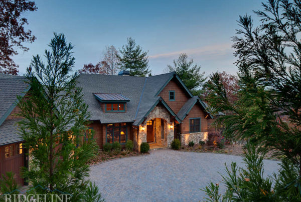 mountain home at dusk with stone detail and brown shackles