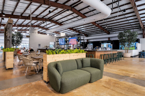 interior lounge space at pickleyard with sofa and other seating areas