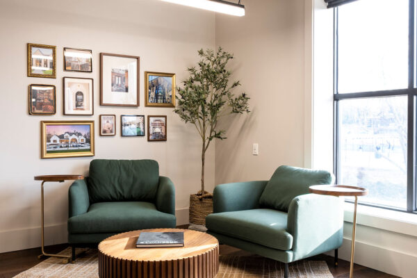 interior of project plus architects buildout - common seating area with two chairs and a table