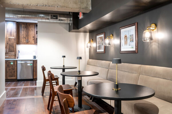 interior of project plus architects buildout- booth against wall with table and chair