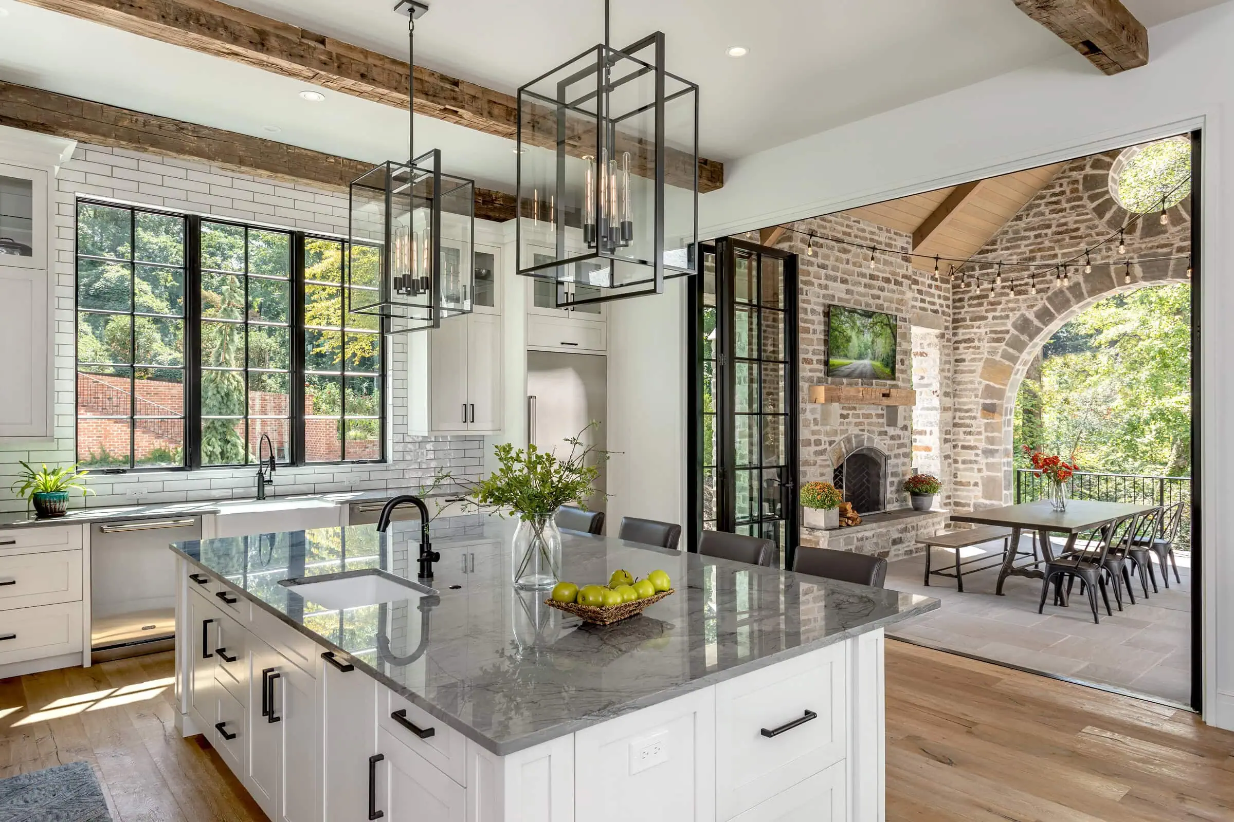 modern interior kitchen with large doors opening onto an exterior covered patio