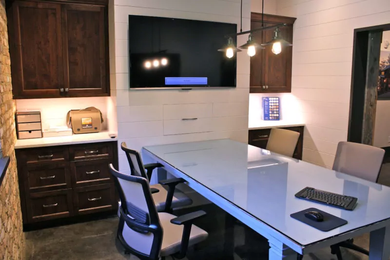 Office space with television and cabinetry