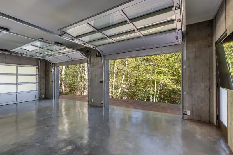 interior garage with 2 open custom glass garage doors
