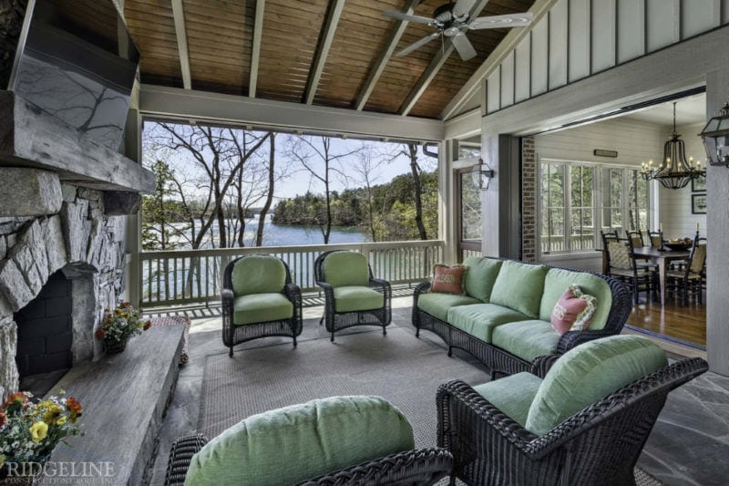 covered outdoor living area with television and fireplace