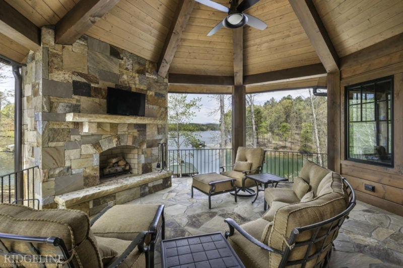 Covered outdoor sitting area with television and fireplace