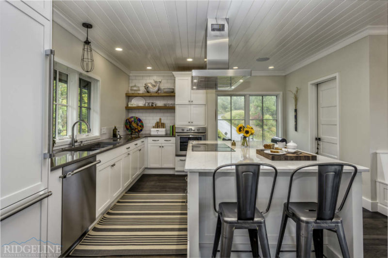white clean kitchen with grey barstool chairs