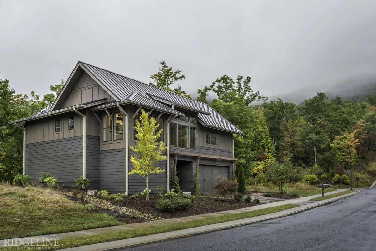 green house surrounded by trees and foggy skies