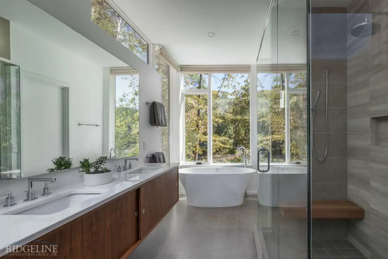 big bathroom with beautiful round tub brown cabinets and big windows