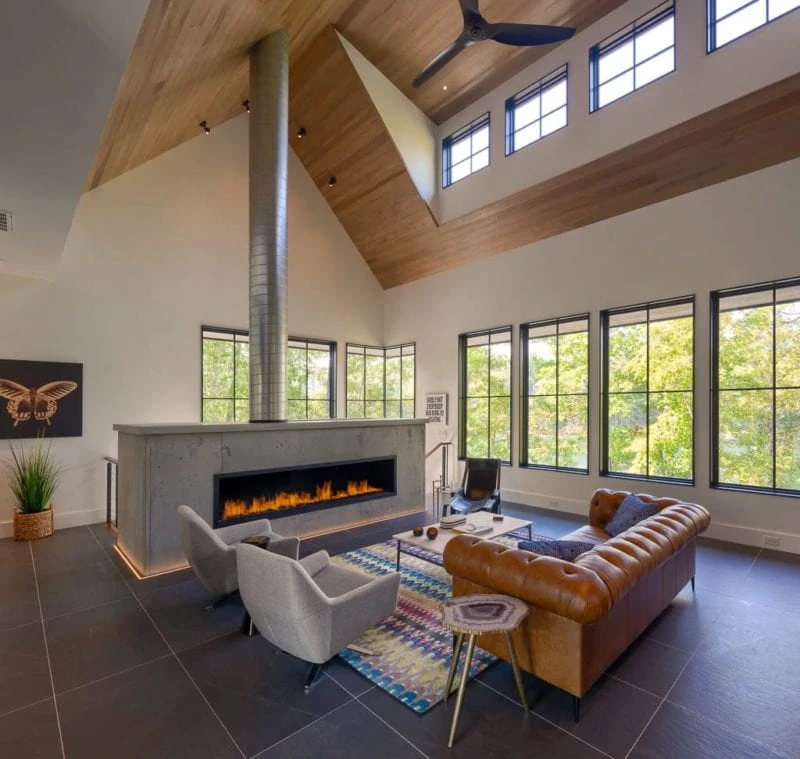 Custom built home featuring living room with lit fireplace