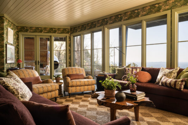 sunroom with large windows, chairs, and couch seating