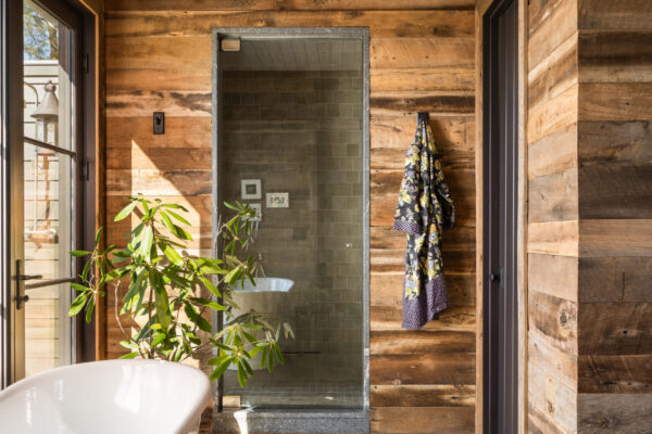 full bathroom in cabin home with soaking tub