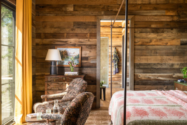 large bedroom with hanging bed in cabin home