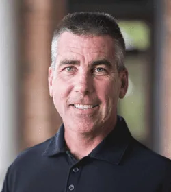 Middle aged man in a black golf shirt
