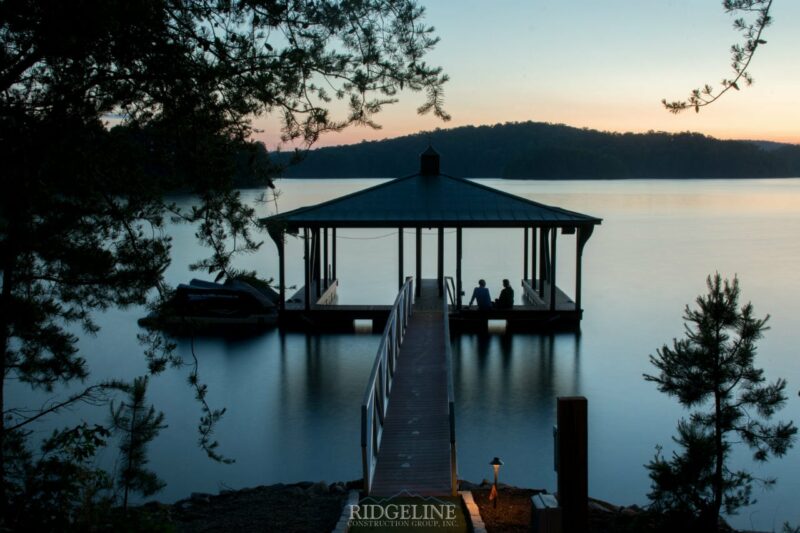 boardwalk and dock going out on the lake with hill in background
