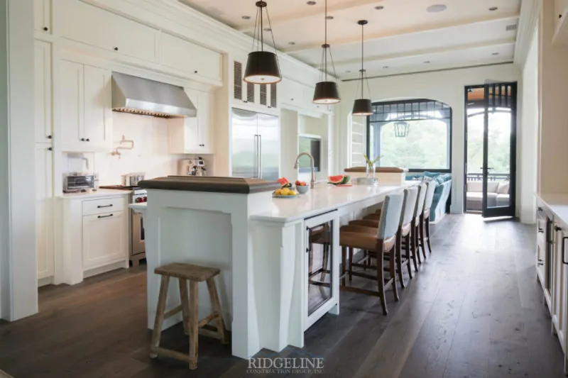 white kitchen with open windows and glass door