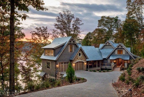 landscape of mountain home on lake with sunset in the background