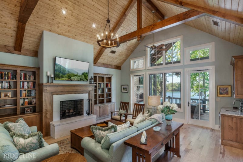 Living room with green couches and exposed beams