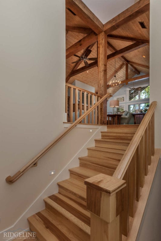 brown staircase leading up to living room