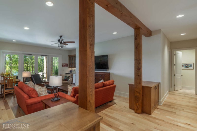 living room with red furniture and exposed brown beams