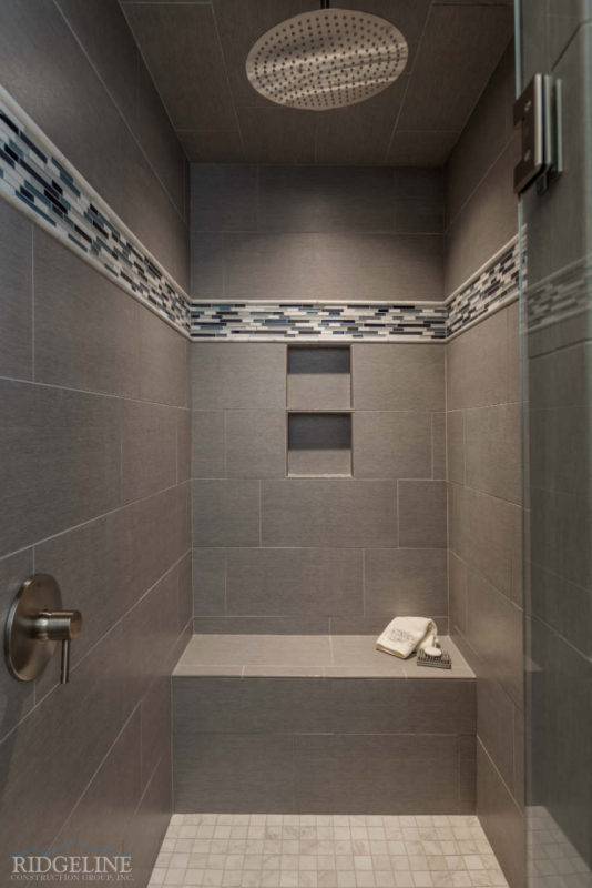 grey walk in shower with built in bench