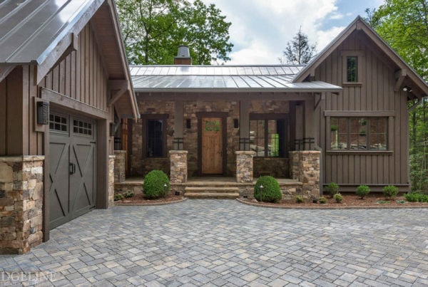 view of garage front door and drive way of wood cabin
