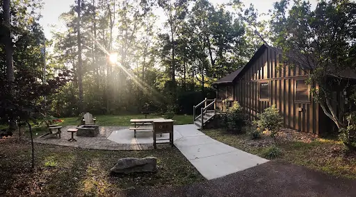 log cabin with fire pit in forest of south carolina mountains