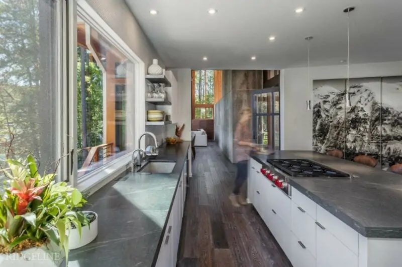 kitchen with open windows and grey soapstone countertops