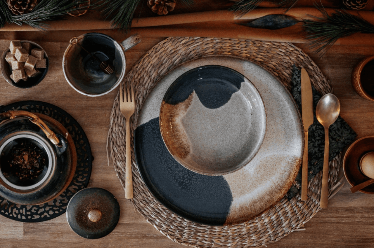 plates, cups and utensils on top of a table