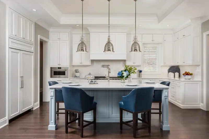 Kitchen Island with Chairs Around it With View of Dining Table and Appliances in Kitchen